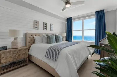 a bedroom with a bed and a large window at Aqua 0806 in Panama City Beach