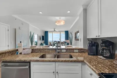 a kitchen with a sink and a counter top at Aqua 0806 in Panama City Beach