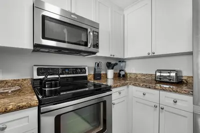 a kitchen with a stove and a microwave at Aqua 0806 in Panama City Beach