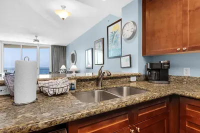 a kitchen with a sink and a counter top at Aqua 1008 in Panama City Beach