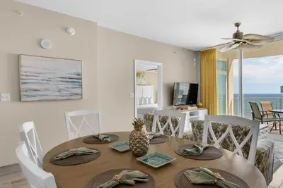 a dining room with a table and chairs at Aqua 1106 in Panama City Beach