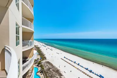 a view of the beach from the balcony of a resort at Aqua 1106 in Panama City Beach