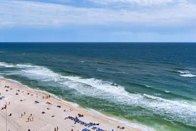 a group of people on a beach near the ocean at Aqua 1106 in Panama City Beach