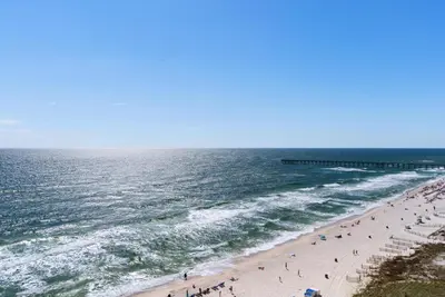 a group of people on a beach near the ocean at Aqua 1106 in Panama City Beach