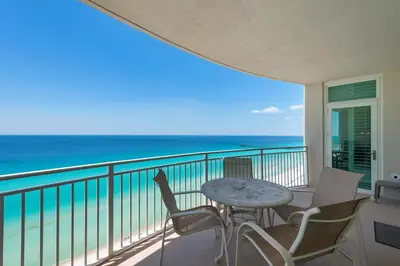 a balcony with a table and chairs and the ocean at Aqua 1703 in Panama City Beach