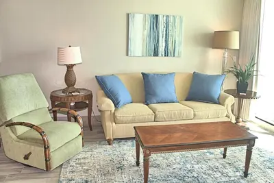 a living room with a couch and a chair at Aqua 1703 in Panama City Beach