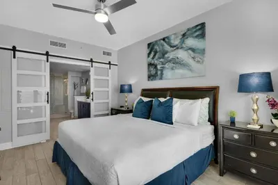 a bedroom with a bed and a ceiling fan at Aqua 0708 in Panama City Beach