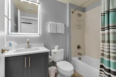 a bathroom with a sink and a toilet and a tub at Aqua 0708 in Panama City Beach