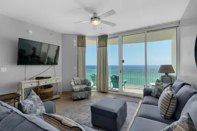 a living room with a view of the ocean at Aqua 1009 in Panama City Beach