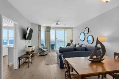 a living room with a couch and a table at Aqua 1009 in Panama City Beach