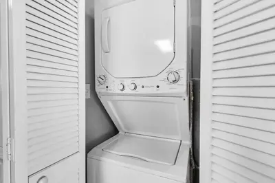 a white washer and dryer in a small room at Aqua 1009 in Panama City Beach