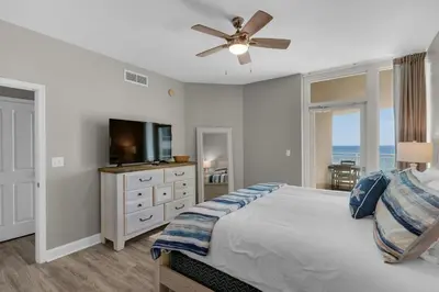 a bedroom with a bed and a flat screen tv at Aqua 0611 in Panama City Beach