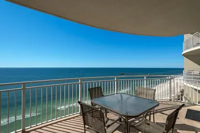 a table and chairs on a balcony with the ocean at Aqua 1708 in Panama City Beach