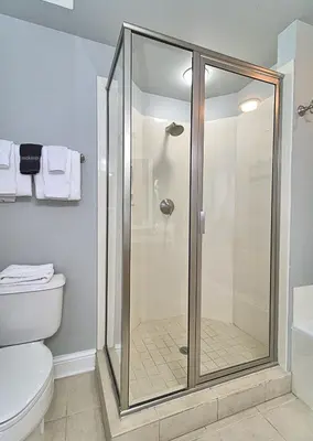 a glass shower in a bathroom with a toilet at Aqua 1510 in Panama City Beach