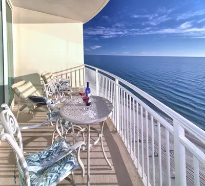 a table and chairs on a balcony overlooking the ocean at Aqua 1510 in Panama City Beach