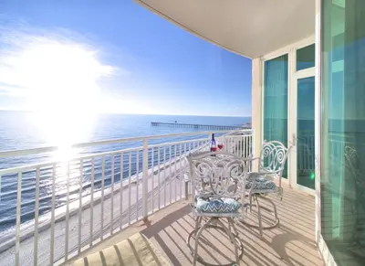 a balcony with a table and chairs and the ocean at Aqua 1510 in Panama City Beach