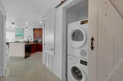 a kitchen with a washer and dryer in a room at Aqua 2110 in Panama City Beach