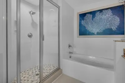 a bathroom with a shower with a glass door at Aqua 2110 in Panama City Beach