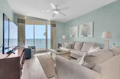 a living room with a large couch and a television at Aqua 1908 in Panama City Beach