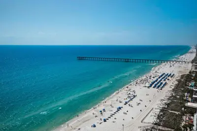 an aerial view of a beach with a pier at Aqua 1908 in Panama City Beach