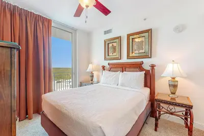 a bedroom with a bed and a window with a view at Aqua 1001 in Panama City Beach