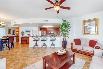 a living room with a couch and a table at Aqua 1001 in Panama City Beach
