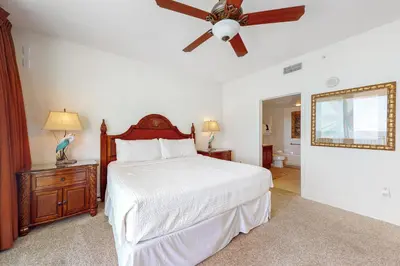 a bedroom with a bed and a ceiling fan at Aqua 1001 in Panama City Beach