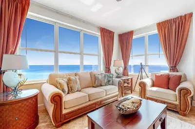 a living room with a couch and a table at Aqua 1001 in Panama City Beach