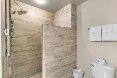 a bathroom with a shower and a toilet at Aqua 0904 in Panama City Beach