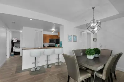 a dining room and kitchen with a table and chairs at Aqua 2211 in Panama City Beach