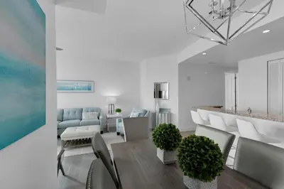 a living room with a dining room table and chairs at Aqua 2211 in Panama City Beach