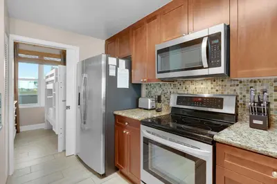 a kitchen with a stove and a microwave at Aqua 0503 in Panama City Beach