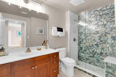 a bathroom with a shower and a sink and a toilet at Aqua 0503 in Panama City Beach