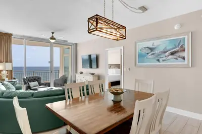 a dining room and living room with a dining table at Aqua 0503 in Panama City Beach