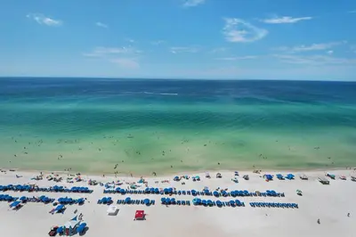 an aerial view of a beach with people and the ocean at Aqua 1409 in Panama City Beach