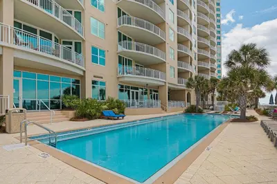 a swimming pool in front of a apartment building at Aqua 0307 in Panama City Beach