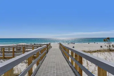 a boardwalk leading to a beach with people on it at Aqua 0307 in Panama City Beach