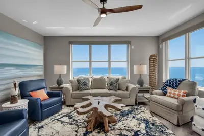 a living room with a couch and chairs and a table at Aqua 1801 in Panama City Beach