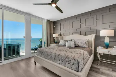 a bedroom with a bed and a view of the ocean at Aqua 1801 in Panama City Beach