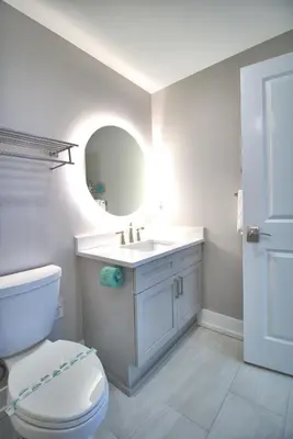 a bathroom with a toilet and a sink and a mirror at Aqua 1801 in Panama City Beach