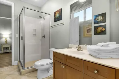 a bathroom with a shower and a toilet and a sink at Aqua 0111 in Panama City Beach