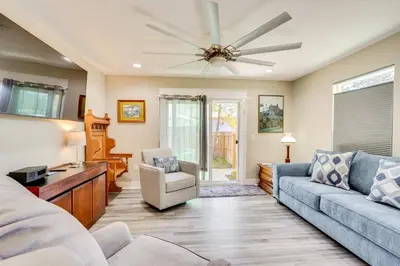 a living room with a couch and a ceiling fan at 1 Mi to Beach Dog-Friendly PCB Home with Backyard! in Panama City Beach