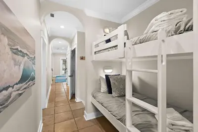 a hallway with bunk beds in a house at Inlet Breeze in Inlet Beach