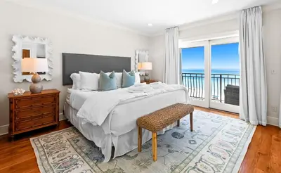 a bedroom with a large bed with a view of the ocean at Five Star in Inlet Beach