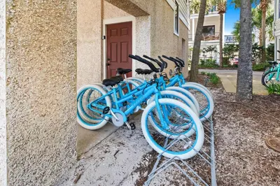 two blue bikes parked on the side of a building at Five Star in Inlet Beach