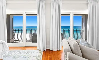 a living room with a view of the ocean at Five Star in Inlet Beach