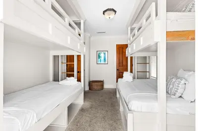 two white bunk beds in a white room at Five Star in Inlet Beach