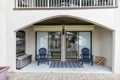 two blue chairs sitting in front of a door at Dune Villas 6A in Santa Rosa Beach