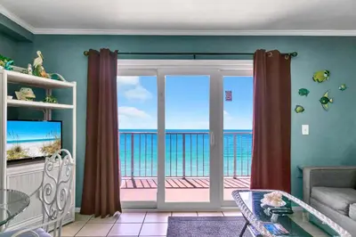 a living room with a view of the ocean at The Summit 1209 in Panama City Beach