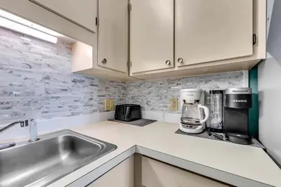 a kitchen with a sink and a coffee maker at The Summit 1209 in Panama City Beach